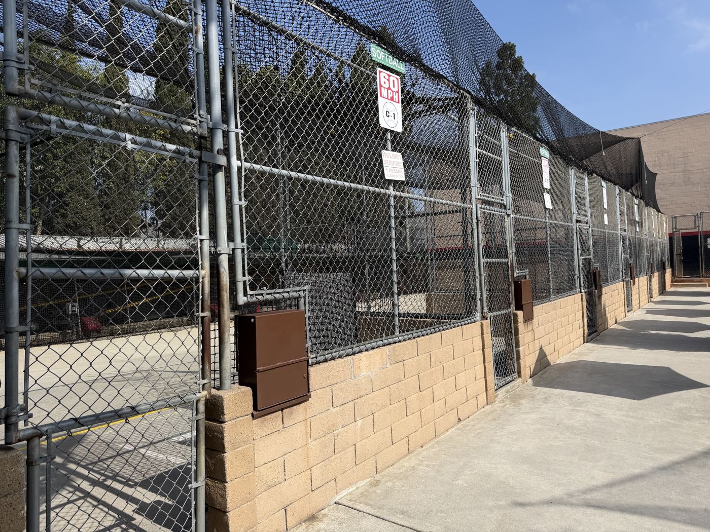 Row of individual batting cage stalls at Home Run Park