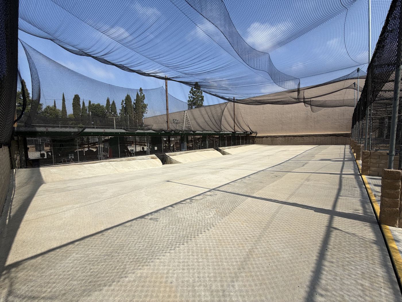 Netted tunnel of batting cage stalls at Home Run Park